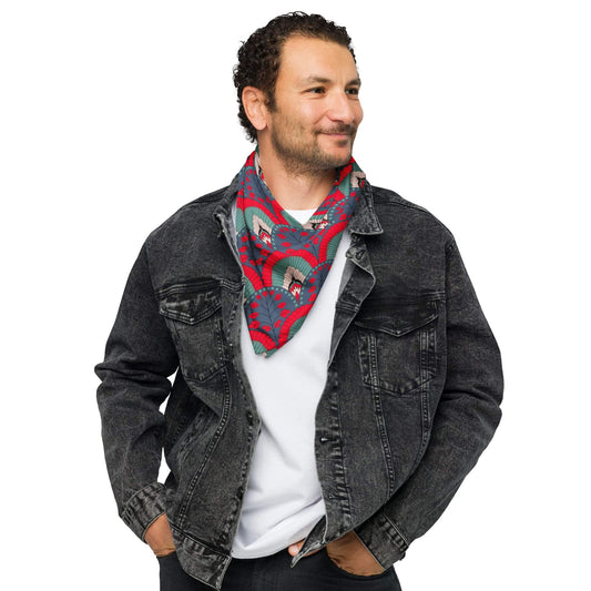 Man wearing a denim jacket and a colorful scallop pattern red navy bandana scarf on a white background
