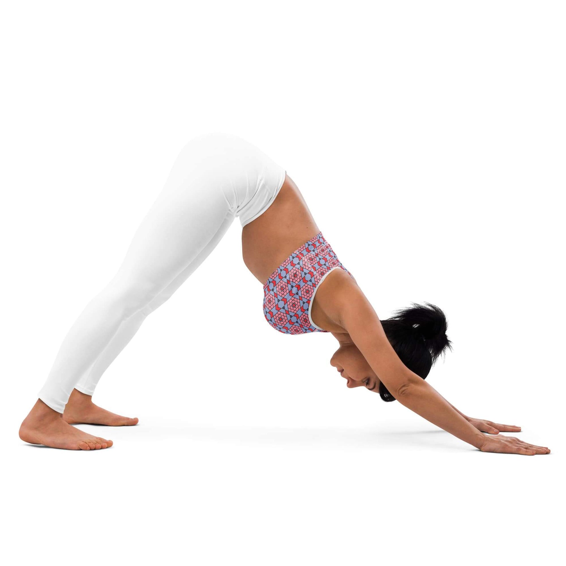 woman performing a yoga pose wearing a one owl artist padded racerback sports bra