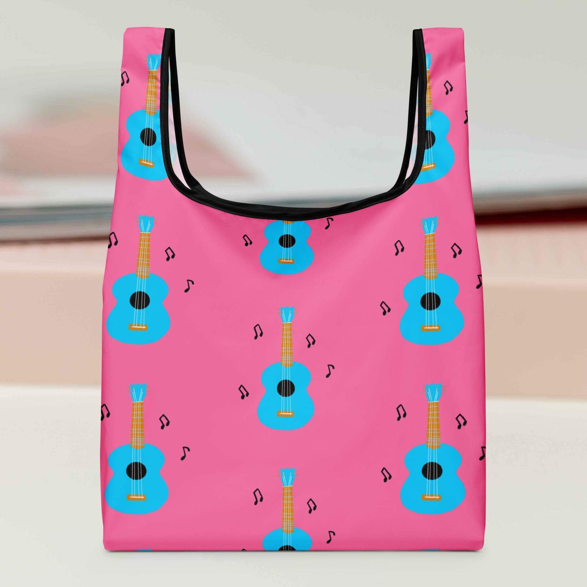 Pink reusable grocery bag with blue ukulele pattern