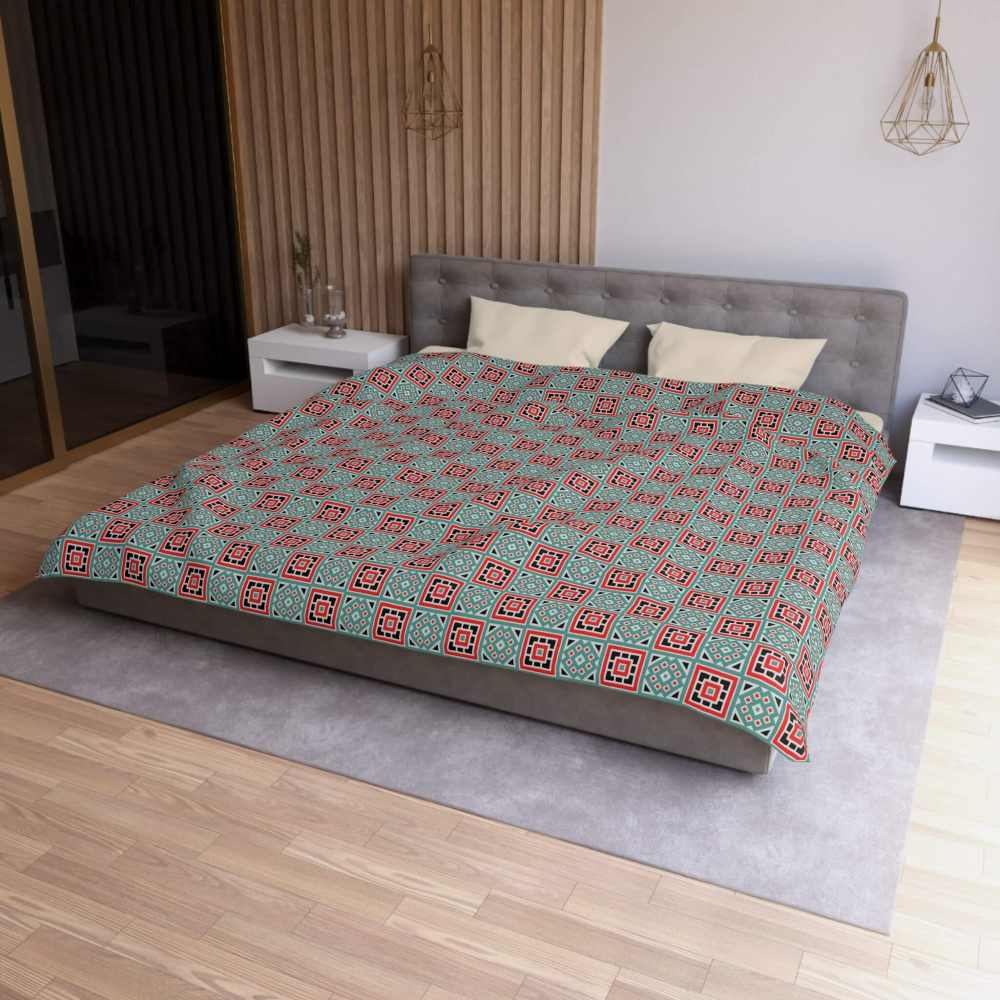 Bed with box patterned king size comforter in a bedroom setting
