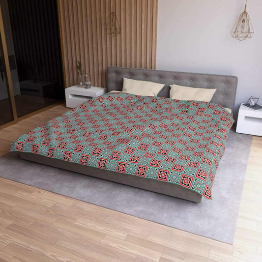 Bed with box patterned king size comforter in a bedroom setting