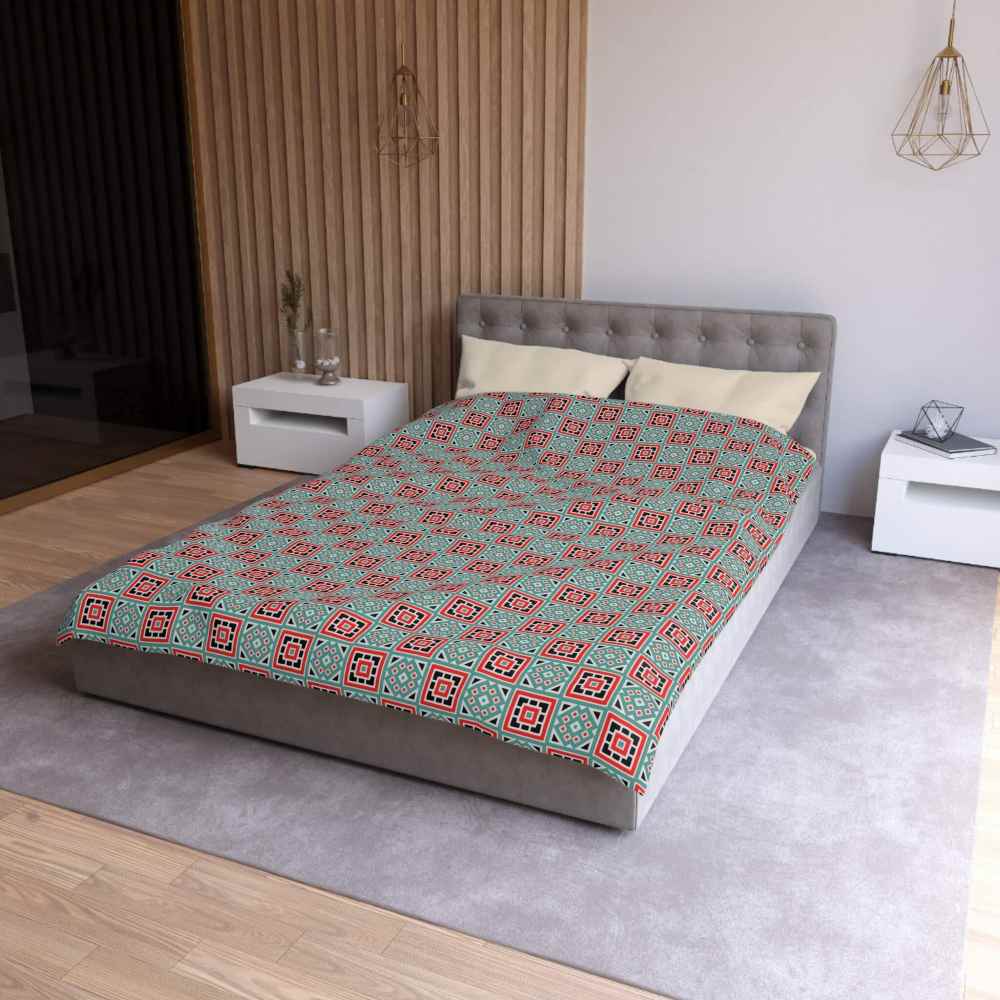 Bed with a box patterned green and red twin size duvet cover in a modern bedroom setting.