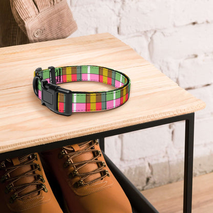 Colorful plaid dog collar on a wooden table with brown boots underneath.