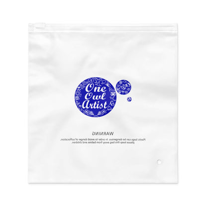 Clear plastic bag with 'One Owl Artist' branding for a plaid dog leash 