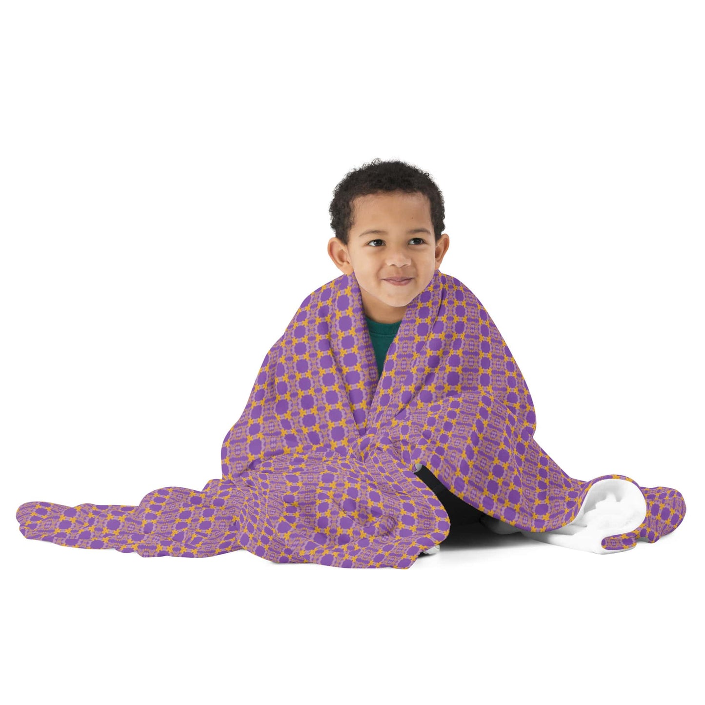Child wrapped in a purple blanket with yellow patterns on a white background