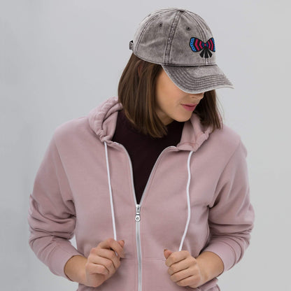 woman wearing a pink hoodie and a gray cotton twill cap with a ribbon bow embroidery designed by one owl artist