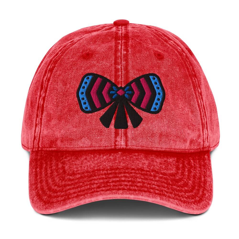 Red cotton twill cap with a colorful ribbon bow design on front