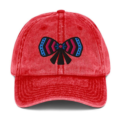 Red cotton twill cap with a colorful ribbon bow design on front